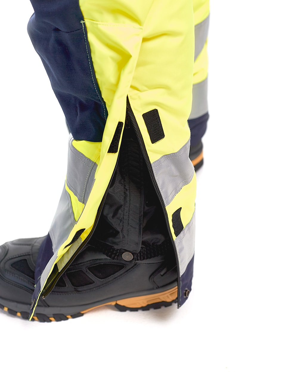 Latzhose Winter Warnschutz, HighVis-Gelb-Marineblau, Detail verstellbarer Beinabbschluss